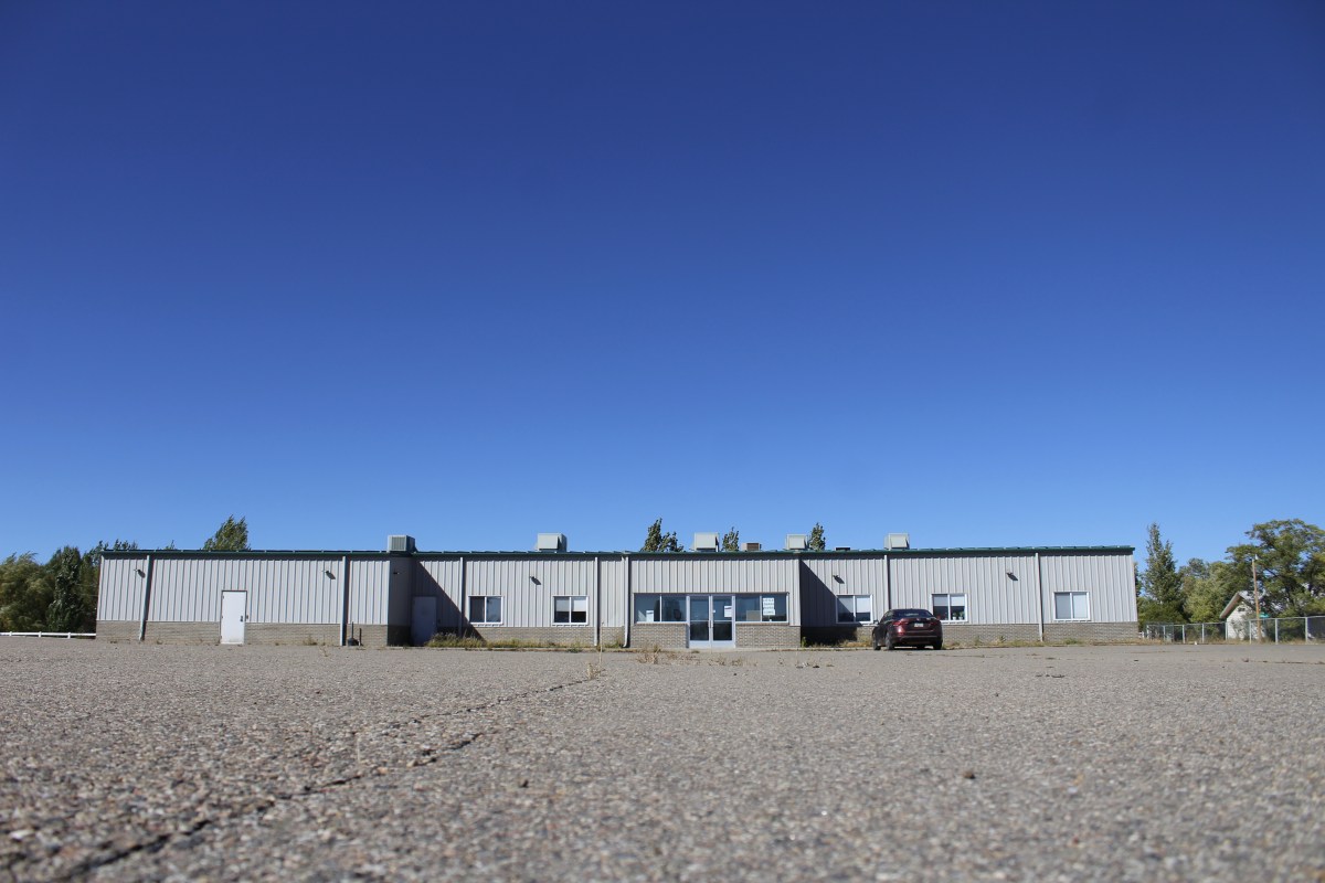A warehouse-style building with a paved parking lot