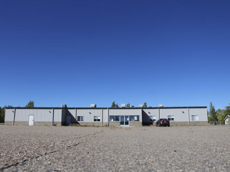 A warehouse-style building with a paved parking lot