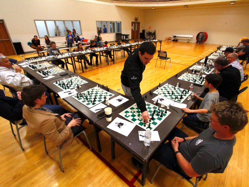 Serbian grandmaster chess player Luka Budisavljević makes a move against an opponent while playing 24 chess games simultaneously against Sheridan enthusiasts of the sport. (Daniel Kenah/WyoFile)