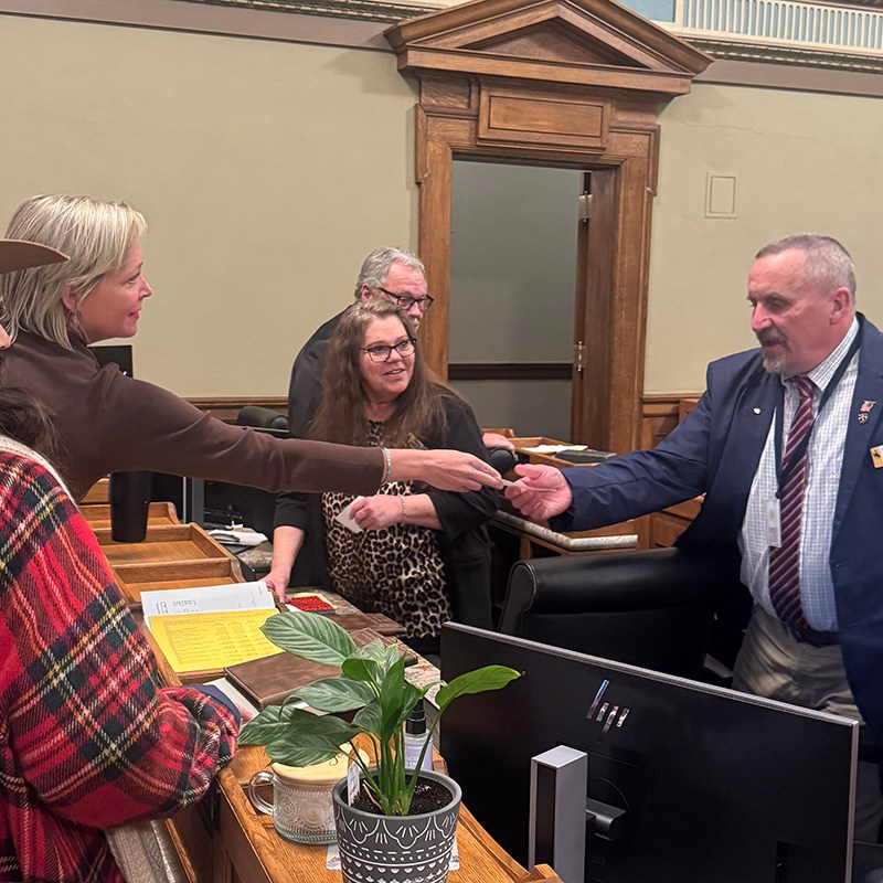 Conservative activist hands checks to lawmakers on Wyoming House floor. Controversy erupts.