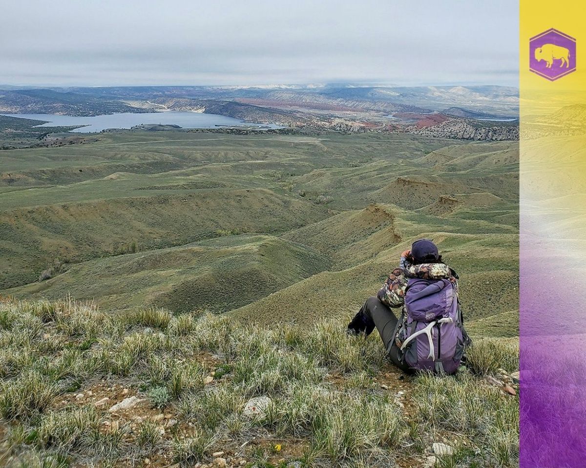 A woman looks for animals near Alcova Reservoir.