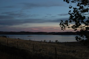 The sun rises over a lake in Wyoming.