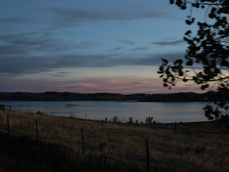 The sun rises over a lake in Wyoming.
